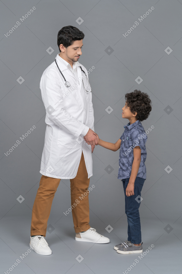 Doctor and child shaking hands