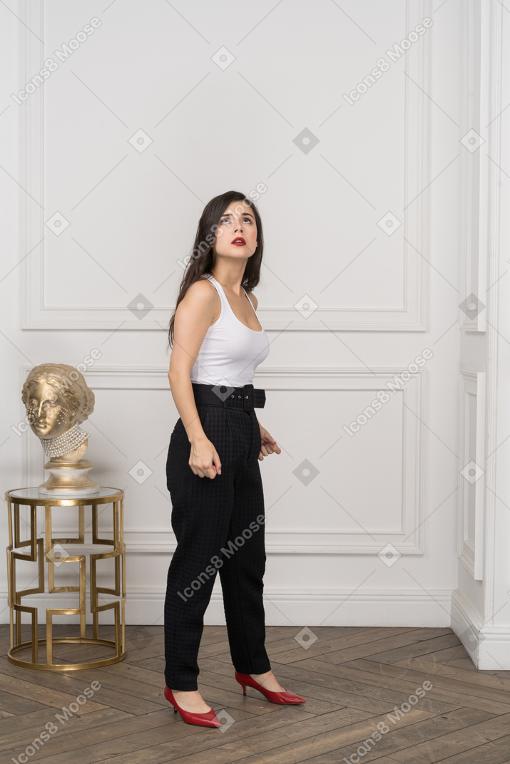 Young businesswoman looking up