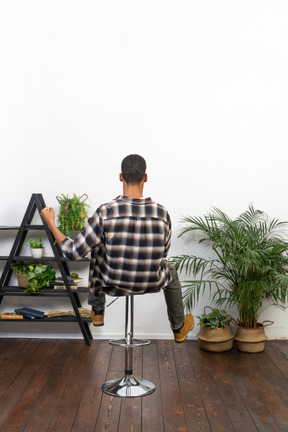 Good looking young man sitting on a chair