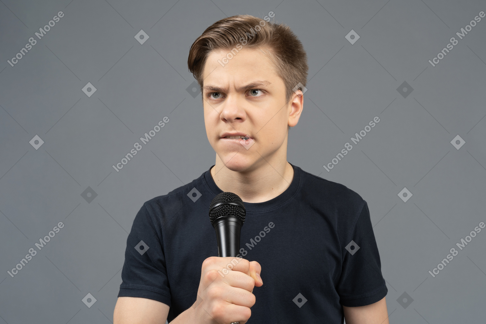Angry young man holding microphone