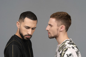 Close-up of a male couple looking stressed as if they are arguing