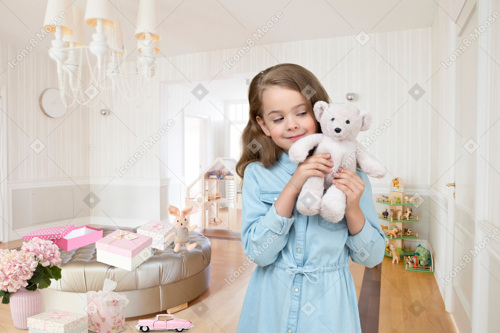 A little girl holding a teddy bear in her hands