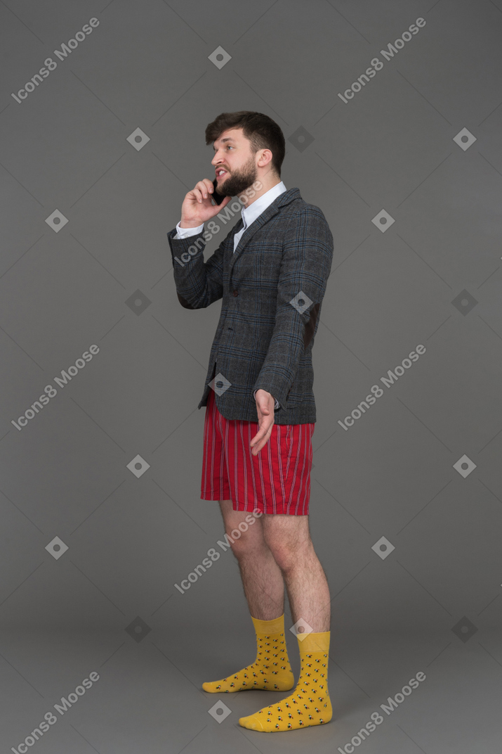 Confused businessman discussing work on the phone