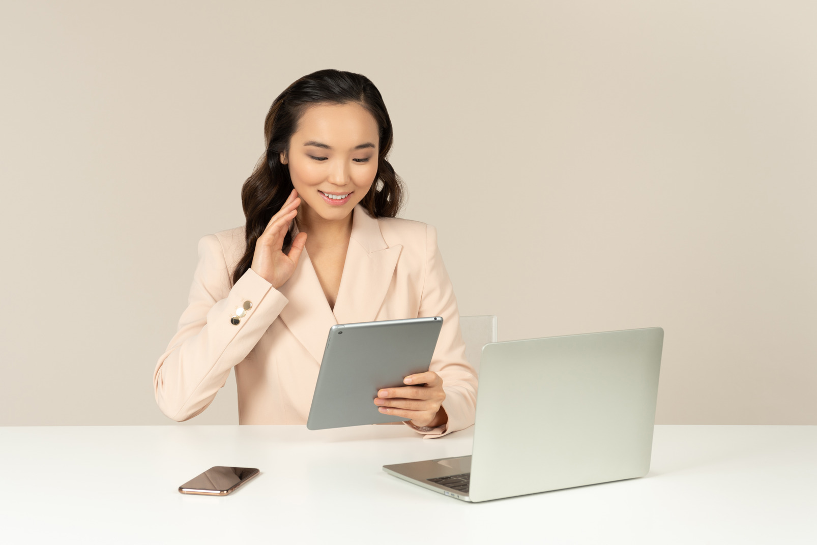 Asian office employee touching face and looking on tablet