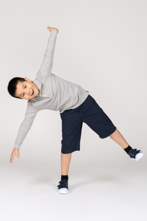 Boy with spread arms looking at camera