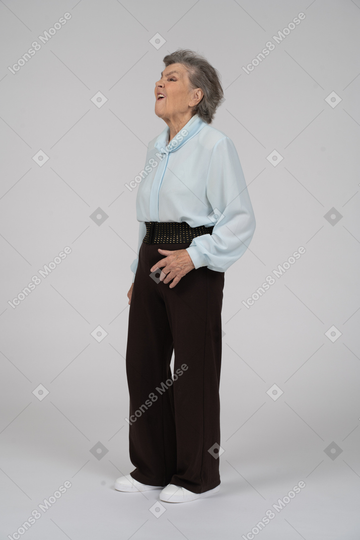 Three-quarter view of an old woman looking up with a grimace