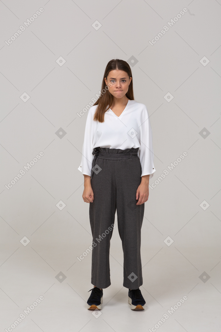Front view of an annoyed young lady in office clothing pressing lips