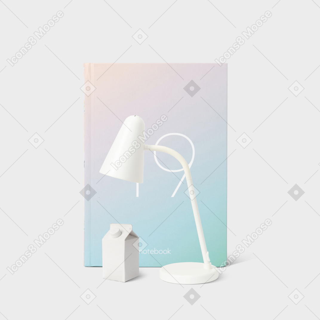 A white table lamp next to a box of milk