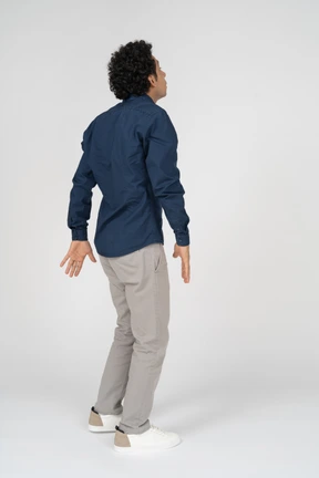 Side view of a man in casual clothes looking up