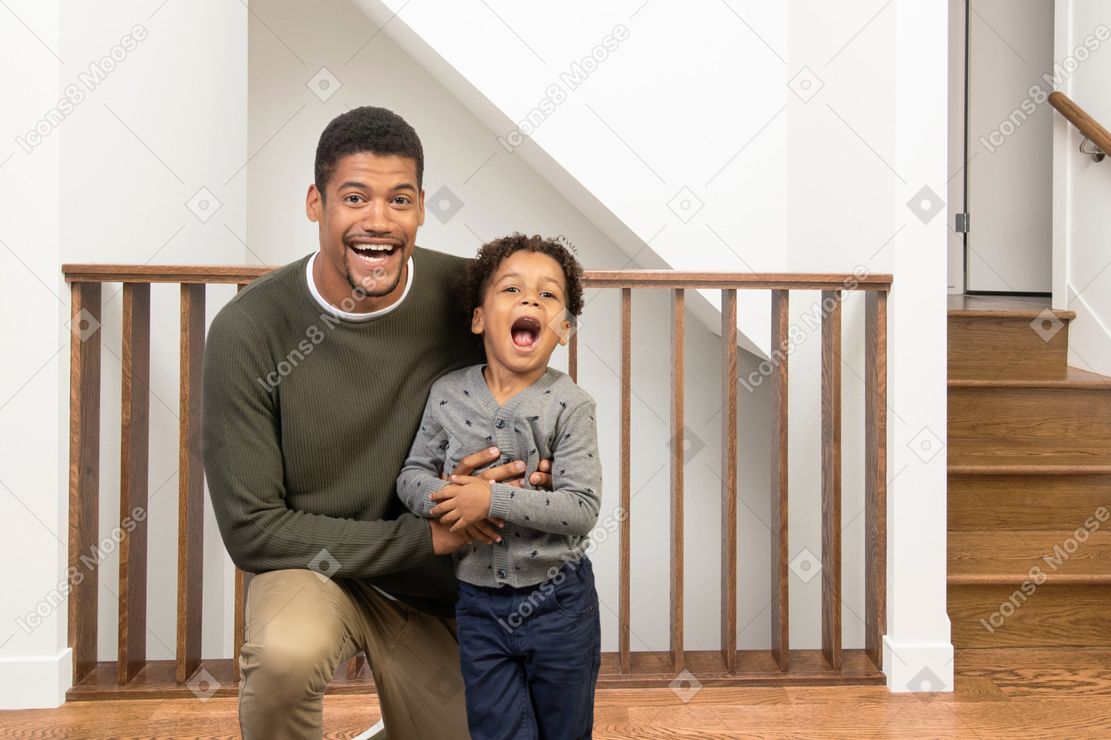 Man and boy laughing at home