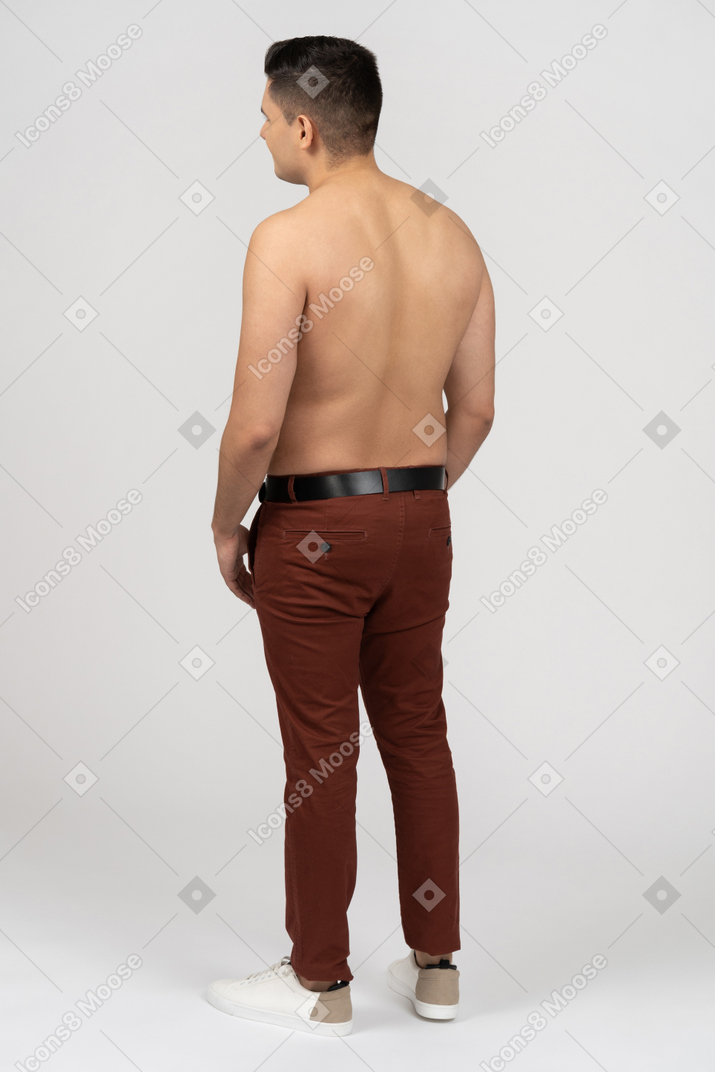 Three-quarter back view of a shirtless latino man