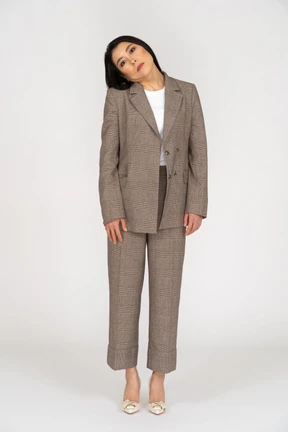 Front view of a young lady in brown business suit tilting head
