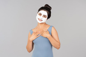 Woman standing with white mask on