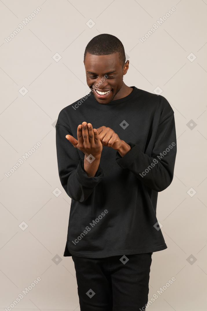 Man using imaginary smartphone and smiling