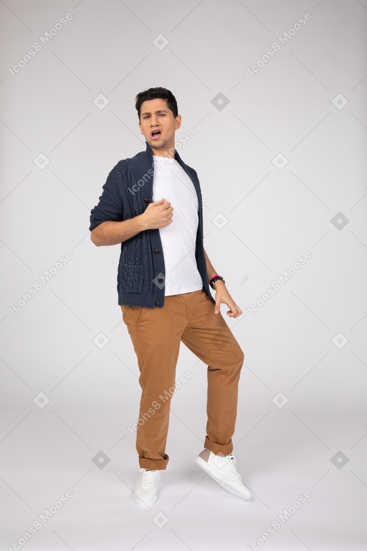 Yawning man in cardigan and pants