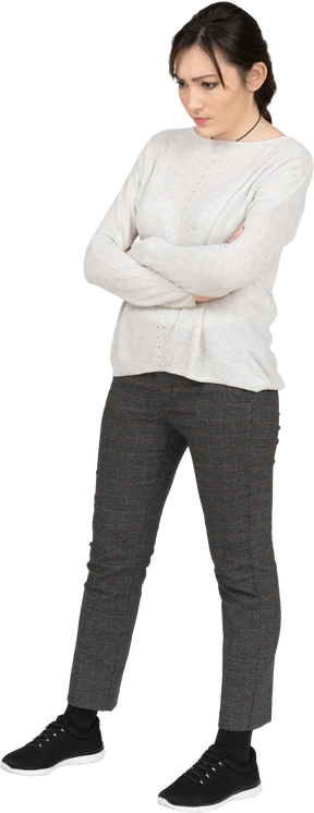 Frown brunette female posing with crossed arms