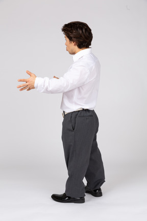 Side view of man in white shirt gesticulating