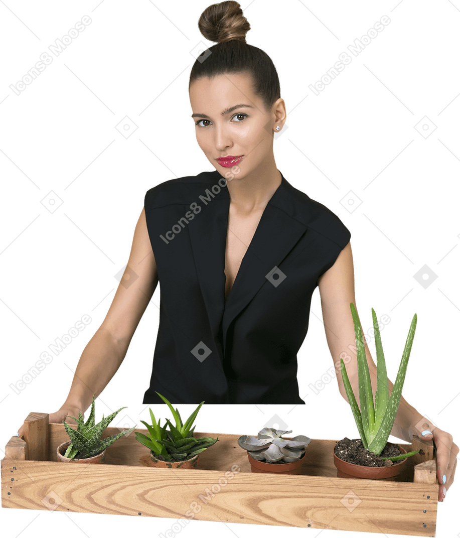 Beautiful young woman taking care of plants
