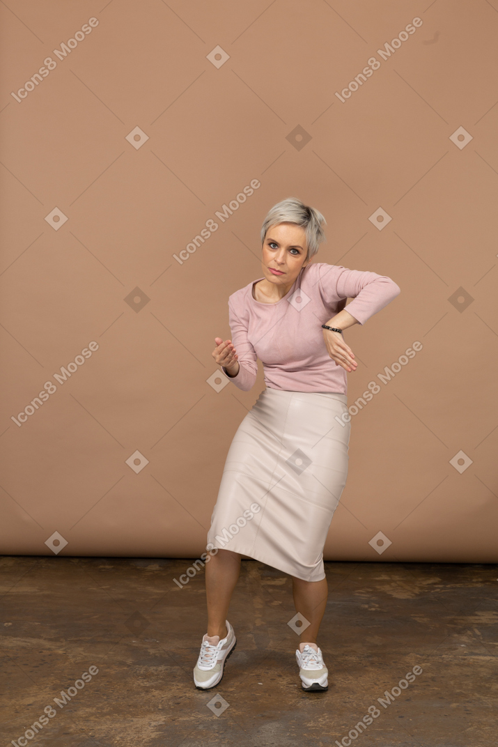 Front view of a woman in casual clothes dancing