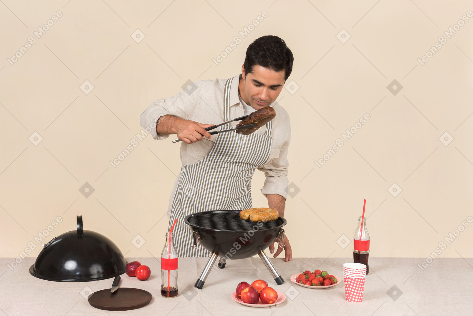 Jeune homme caucasien prépare un barbecue