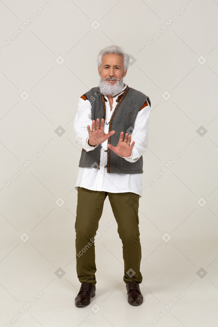 Worried man in casual clothes raising his hands