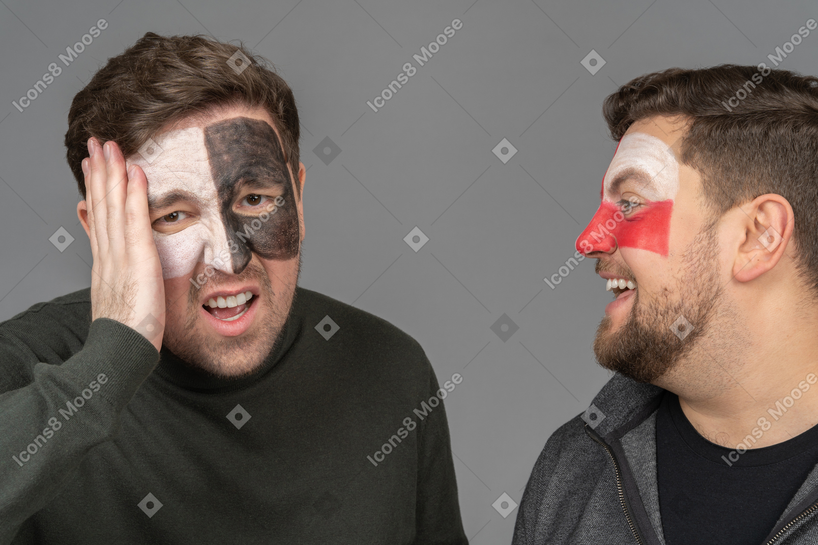 Front view of two male football fans sharing their emotions