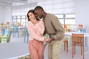 Young couple laughing in cafeteria