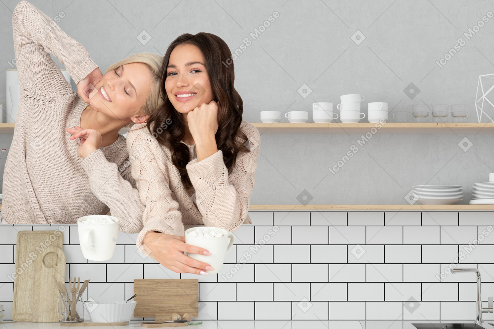 A couple of women drinking cocoa in a kitchen