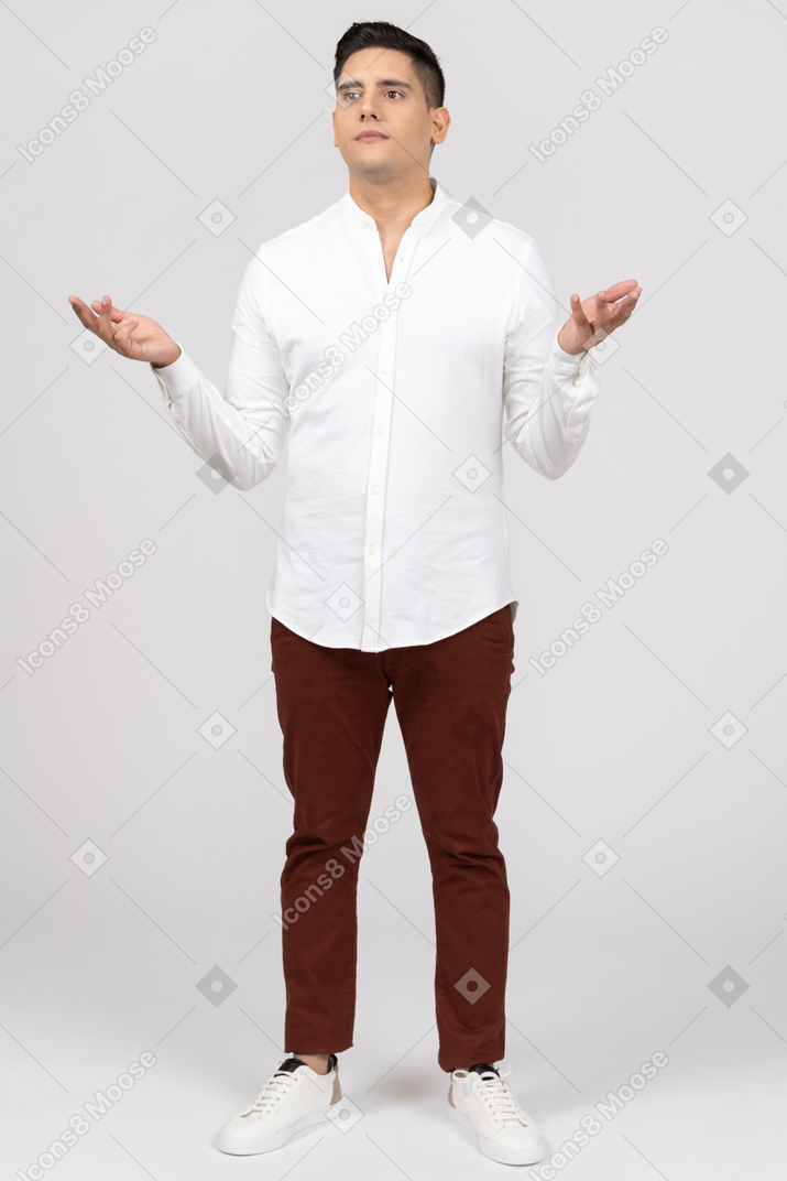 Front view of a young latino man raising his hands in disappointment