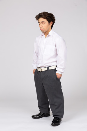 Male office worker standing with his eyes closed