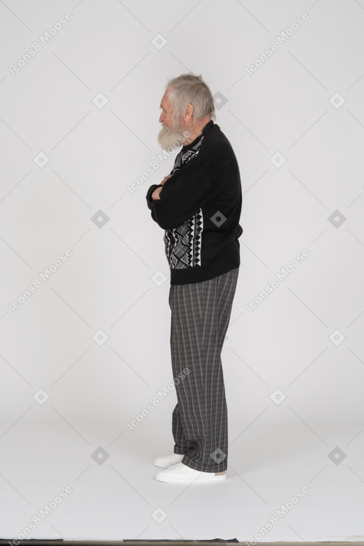 Side view of old man with folded arms