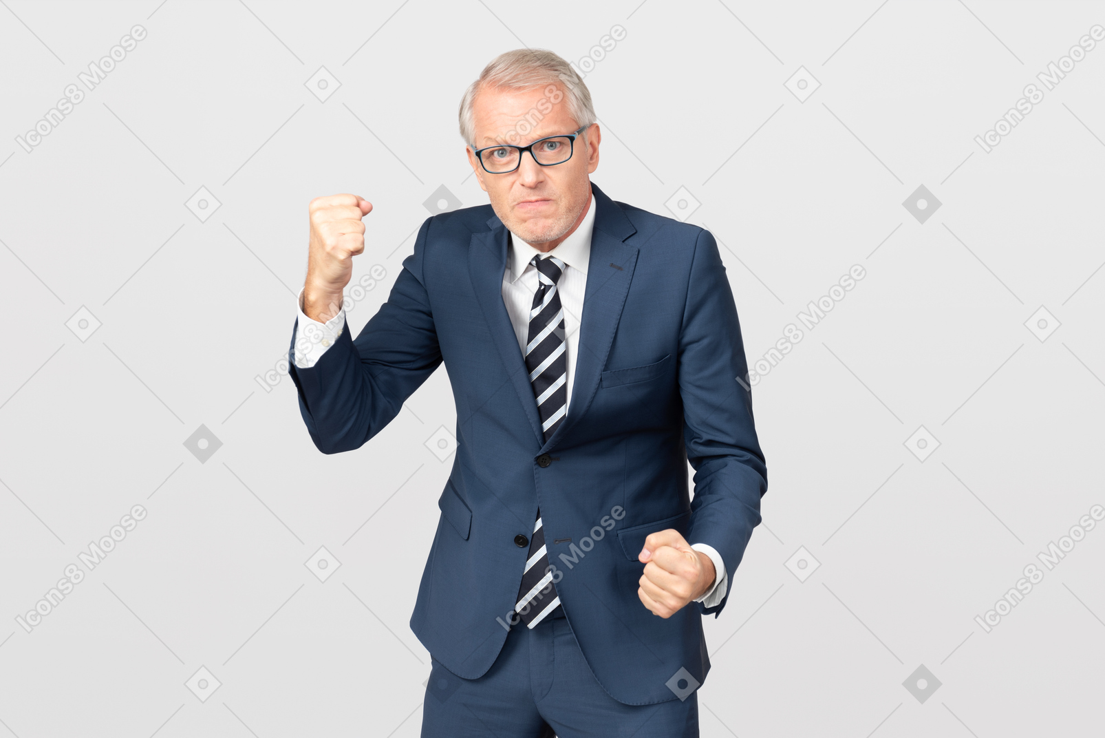 Angry middle aged businessman holding his fists up