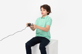 Cute boy playing video game