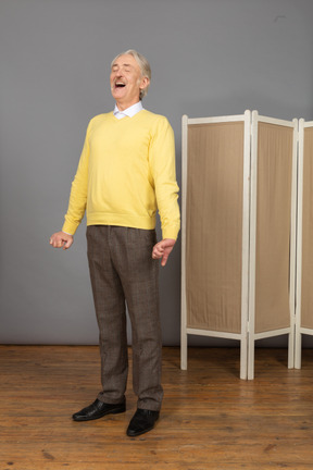 Three-quarter view of a screaming old man standing still