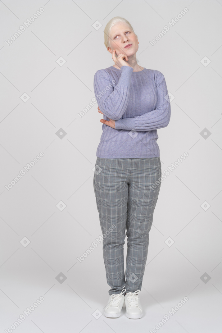 Young woman touching her face while thinking