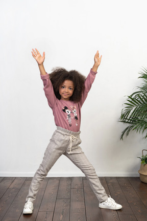 Cute girl kid posing on the apartments background