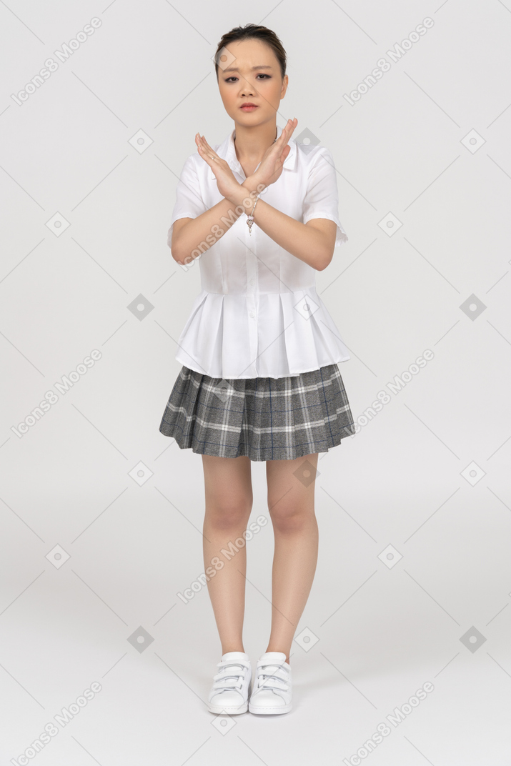 Serious asian girl making a "no more" gesture