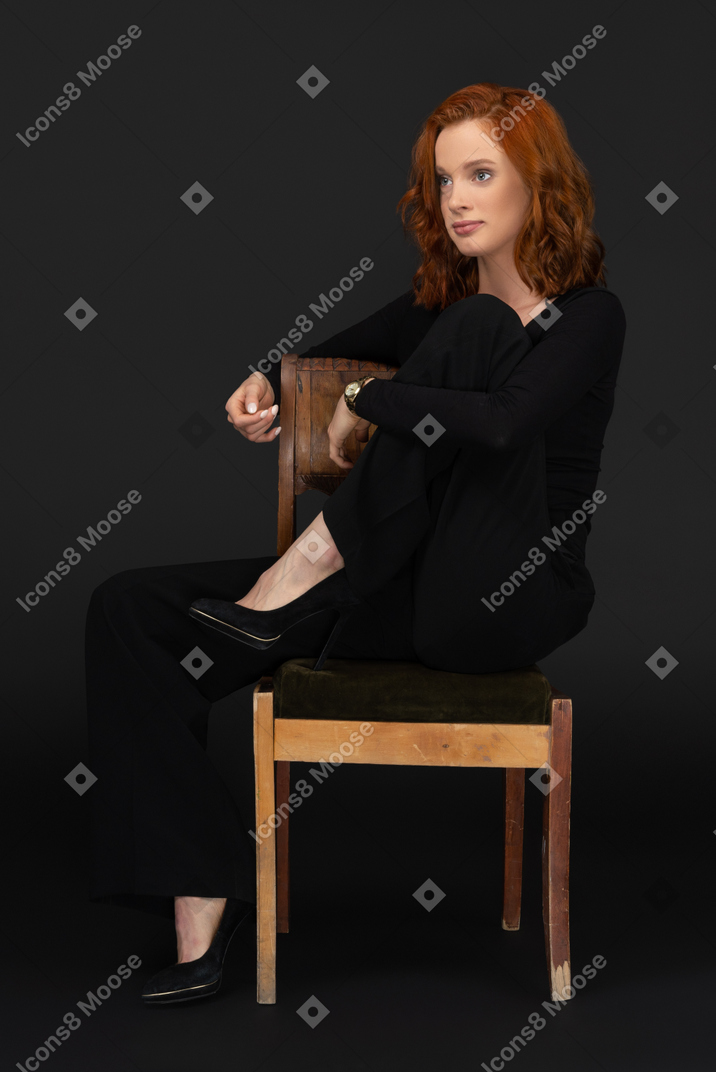 Ginger woman sitting on a chair