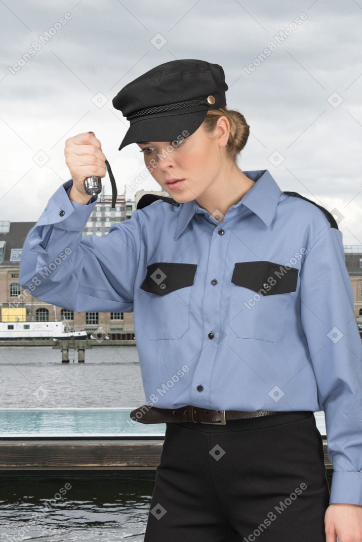 Young businessman looking through binoculars in the harbor
