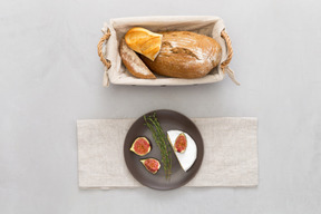 A loaf of bread and some figs on a plate