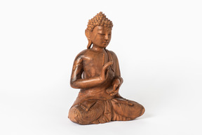 Buddha statue placed half sideways on white background