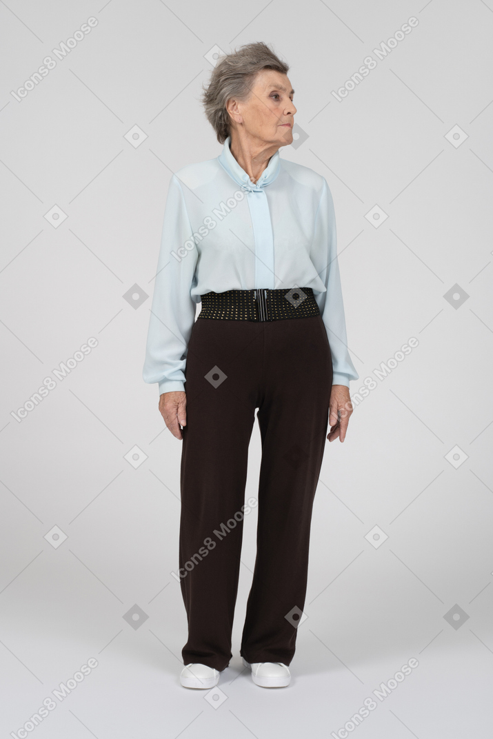 Old woman standing and turning head