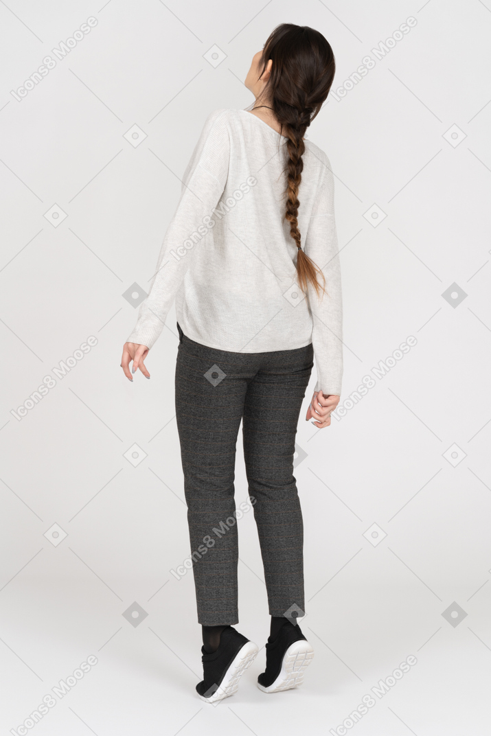 Unrecognizable female standing on tiptoes on white background