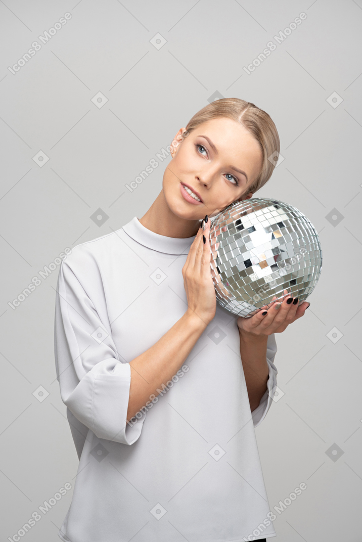 Young woman holding a disco ball