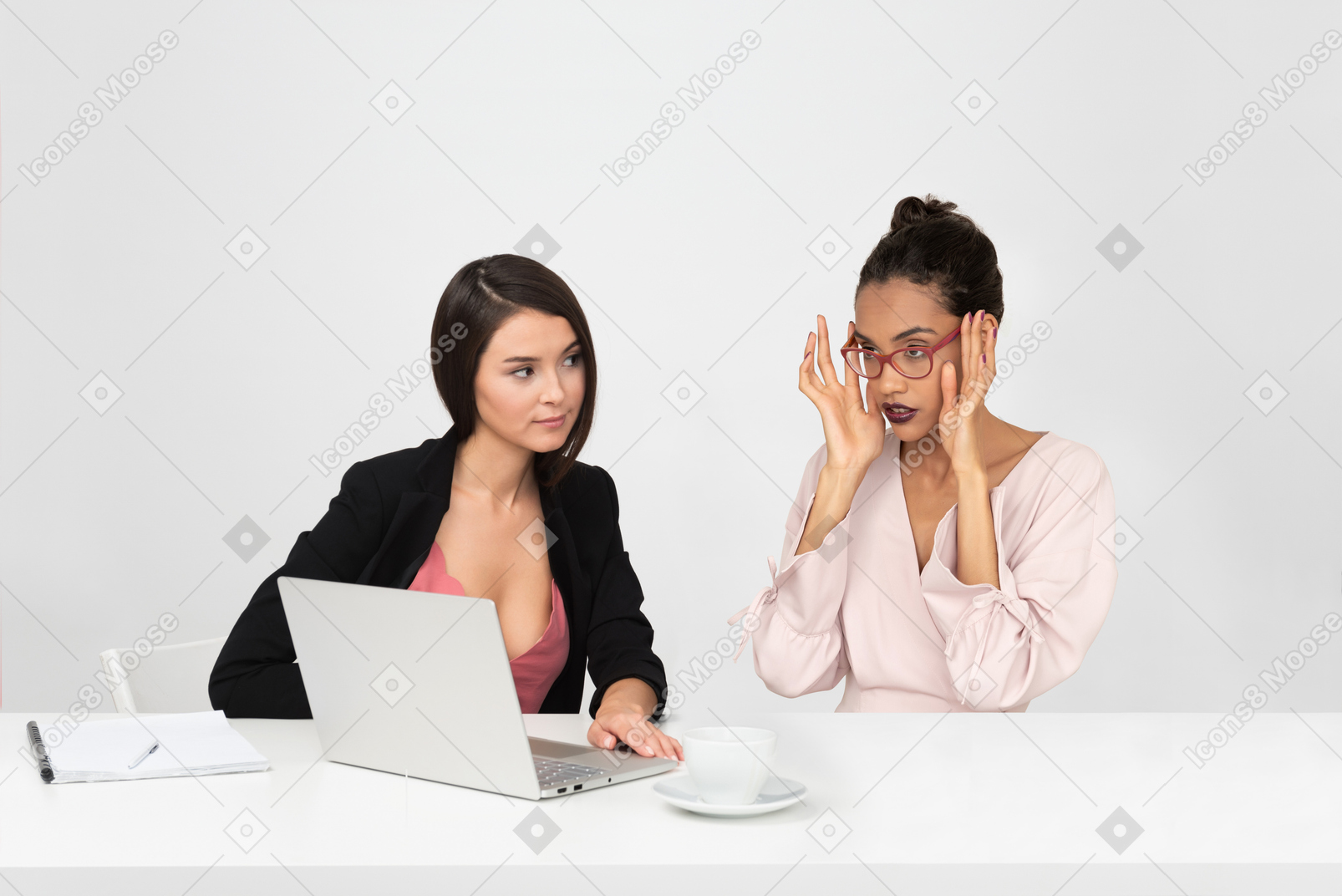 Attractive woman showing something shocking to her colleague