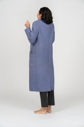 Rear view of an excited woman in a coat