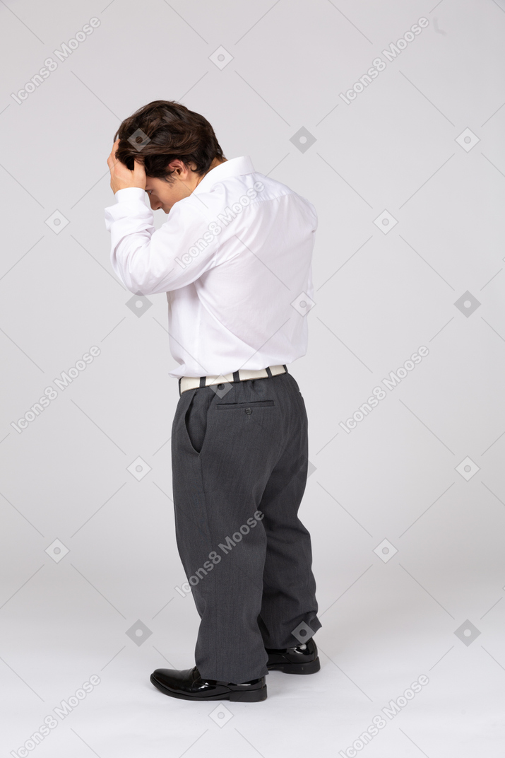 Side view of businessman touching forehead