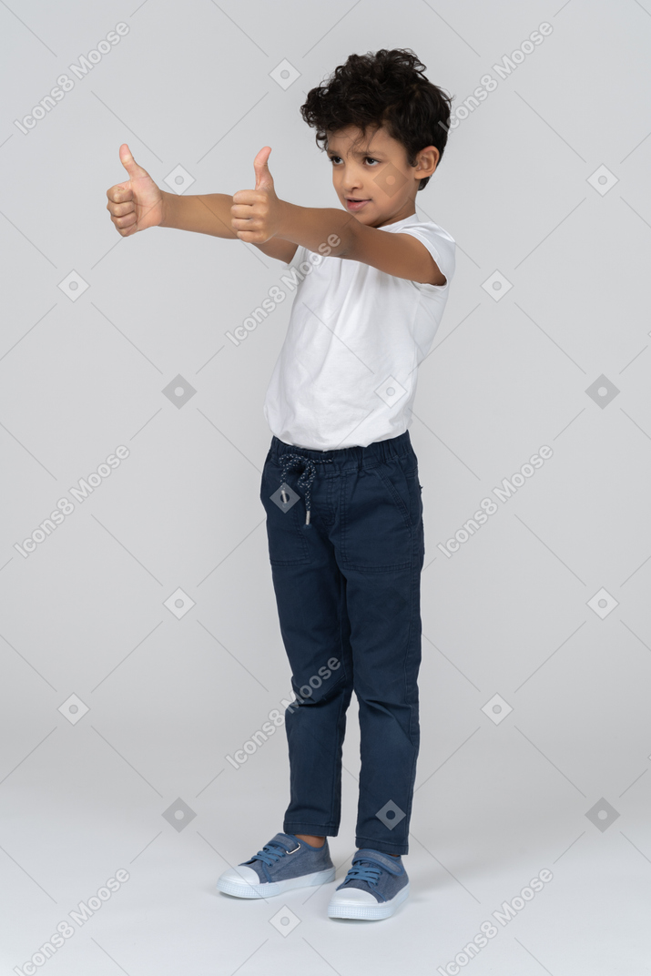 A boy showing two thumbs up