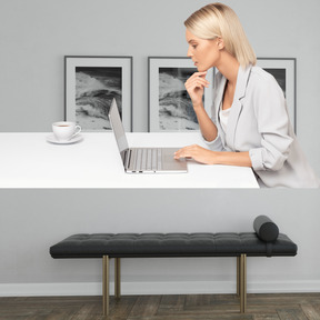 A woman sitting at a desk using a laptop computer