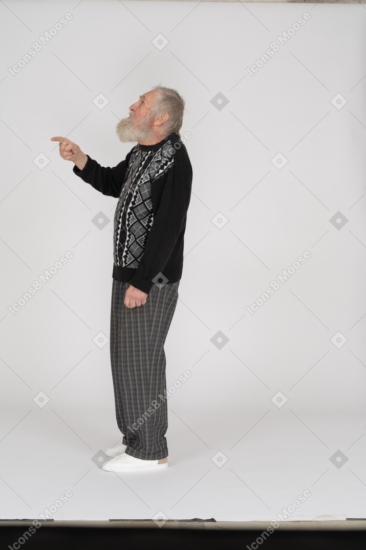 Side view of old man looking up and gesturing